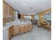 Open layout kitchen with breakfast bar overlooking the dining area and an integrated living room space at 12022 Granite Woods Loop, Venice, FL 34292
