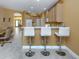 Open-concept kitchen featuring a breakfast bar with seating and a view into the dining area at 12022 Granite Woods Loop, Venice, FL 34292