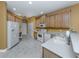Spacious kitchen featuring updated appliances, tile flooring, and ample cabinet space at 12022 Granite Woods Loop, Venice, FL 34292