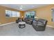 Comfortable living room featuring an electric fireplace, neutral furnishings, and a view of the backyard at 12022 Granite Woods Loop, Venice, FL 34292