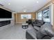 Spacious living room features an electric fireplace, leather seating, and sliding doors to the lanai at 12022 Granite Woods Loop, Venice, FL 34292