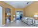 Cozy living room with tile flooring, comfortable seating, and sliding doors leading to the pool area at 12022 Granite Woods Loop, Venice, FL 34292