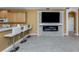Kitchen breakfast bar offering integrated living with stone fireplace and large screen tv at 12022 Granite Woods Loop, Venice, FL 34292