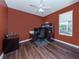 Office room with a large desk with built-in cabinets, wood floors, and natural light at 12022 Granite Woods Loop, Venice, FL 34292