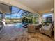 Enclosed lanai with a swimming pool, a spa and view of lake and landscaping at 12022 Granite Woods Loop, Venice, FL 34292