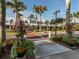 Charming street view with decorative planters filled with colorful flowers, shops, and palm trees at 12022 Granite Woods Loop, Venice, FL 34293