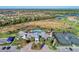Aerial view of the community featuring a pool, tennis courts, and surrounding homes at 12448 Golden Sage Dr, Sarasota, FL 34238