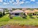 Aerial view of a private screened-in pool and lush green backyard that meet a tranquil water view at 12448 Golden Sage Dr, Sarasota, FL 34238