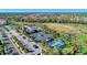 Aerial view showcases community amenities including a pool, tennis courts, and lush landscaping at 12448 Golden Sage Dr, Sarasota, FL 34238