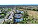Aerial view of community amenities; pool, tennis and pickleball courts, clubhouse, parking and green space at 12448 Golden Sage Dr, Sarasota, FL 34238