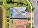 Aerial view of property featuring screened-in pool, lush landscaping, and paved driveway at 12448 Golden Sage Dr, Sarasota, FL 34238