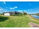 Manicured backyard with a screened-in lanai and pond view, offering serene outdoor living and privacy at 12448 Golden Sage Dr, Sarasota, FL 34238