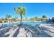 Community pool offers a relaxing atmosphere with lounge chairs and lush tropical landscaping at 12448 Golden Sage Dr, Sarasota, FL 34238