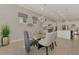 Elegant dining room featuring a glass table, stylish lighting, and comfortable chairs at 12448 Golden Sage Dr, Sarasota, FL 34238