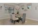 Elegant dining room with modern lighting, stylish decor, and comfortable seating at 12448 Golden Sage Dr, Sarasota, FL 34238
