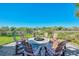 A fire pit surrounded by Adirondack chairs, set on a brick patio, perfect for outdoor gatherings at 12448 Golden Sage Dr, Sarasota, FL 34238