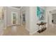 Elegant foyer featuring tiled floors, decorative artwork, and a stylish console table creating a welcoming ambiance at 12448 Golden Sage Dr, Sarasota, FL 34238