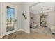 Inviting foyer showcasing tile floors, glass-paneled front door, and an open view to the formal sitting area at 12448 Golden Sage Dr, Sarasota, FL 34238