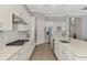 Spacious kitchen featuring stainless steel appliances, an island, and white cabinetry at 12448 Golden Sage Dr, Sarasota, FL 34238