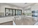 Kitchen area featuring stainless steel appliances, tile backsplash, decorative art, and natural light from adjacent windows at 12448 Golden Sage Dr, Sarasota, FL 34238