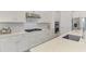 Bright kitchen with stainless steel appliances, white cabinets, and stylish backsplash at 12448 Golden Sage Dr, Sarasota, FL 34238