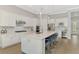 Gourmet kitchen with white cabinets, stainless steel appliances, and a large center island with seating at 12448 Golden Sage Dr, Sarasota, FL 34238