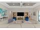 Comfortable living room showcasing built-in shelves, recessed lights, and stylish blue armchairs at 12448 Golden Sage Dr, Sarasota, FL 34238