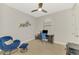 Well-lit home office with a modern desk, comfortable chair, and sleek ceiling fan at 12448 Golden Sage Dr, Sarasota, FL 34238
