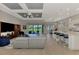 Open concept living area featuring a modern kitchen, dining space, and comfortable lounge with pool view at 12448 Golden Sage Dr, Sarasota, FL 34238