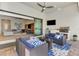 Spacious outdoor patio with an outdoor kitchen, comfortable seating, and scenic views at 12448 Golden Sage Dr, Sarasota, FL 34238
