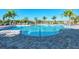 Community outdoor pool with lounge chairs and sunny skies at 12448 Golden Sage Dr, Sarasota, FL 34238