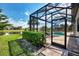 View of the screened-in lanai featuring a pool and spa, providing a private oasis with pond views at 12448 Golden Sage Dr, Sarasota, FL 34238