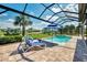 The screened lanai offers a refreshing pool and spa, complemented by comfortable lounge chairs and picturesque views at 12448 Golden Sage Dr, Sarasota, FL 34238