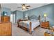 Comfortable main bedroom with a ceiling fan, wood furniture, and calming paint at 12805 49Th E Ln, Parrish, FL 34219