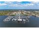Wide aerial view of marina with many boats docked and building at the end of pier beneath a cloudy, blue sky at 1302 5Th W St, Palmetto, FL 34221