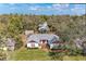 Aerial view of the home with mature trees, manicured lawn, and a charming entrance at 1302 5Th W St, Palmetto, FL 34221