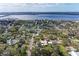 This aerial view showcases a charming neighborhood near the bay, lush with mature trees and green spaces at 1302 5Th W St, Palmetto, FL 34221