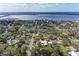 This aerial view showcases a charming neighborhood near the bay, lush with mature trees and green spaces at 1302 5Th W St, Palmetto, FL 34221
