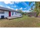 Backyard with a wooden deck, shed, mature trees, and a small playset at 1302 5Th W St, Palmetto, FL 34221