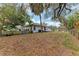 Spacious backyard with a wooden deck, shed, and mature trees at 1302 5Th W St, Palmetto, FL 34221