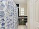 Classic bathroom features white tile floor, and blue floral curtain at 1302 5Th W St, Palmetto, FL 34221
