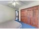 Cozy bedroom with a ceiling fan, spacious closet, and blue carpeting at 1302 5Th W St, Palmetto, FL 34221