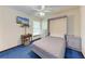 Bedroom with Murphy bed, TV, ceiling fan, and bright blue carpeting at 1302 5Th W St, Palmetto, FL 34221