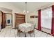 Cozy dining room with a charming hutch, traditional table, and window with red curtains at 1302 5Th W St, Palmetto, FL 34221