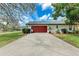 Wide driveway leading to a two-car garage, framed by green landscaping at 1302 5Th W St, Palmetto, FL 34221