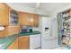 Traditional kitchen features wood cabinets, green countertops, and white appliances at 1302 5Th W St, Palmetto, FL 34221