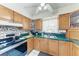 Traditional kitchen with wooden cabinetry, green countertops, and stainless steel appliances at 1302 5Th W St, Palmetto, FL 34221
