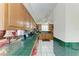 Galley kitchen with wood cabinets, green countertops and view into the living room at 1302 5Th W St, Palmetto, FL 34221
