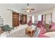 Cozy living room featuring a ceiling fan, sliding bookcase and comfortable seating at 1302 5Th W St, Palmetto, FL 34221
