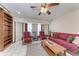 Cozy living room featuring a ceiling fan, bookshelves and comfortable seating at 1302 5Th W St, Palmetto, FL 34221